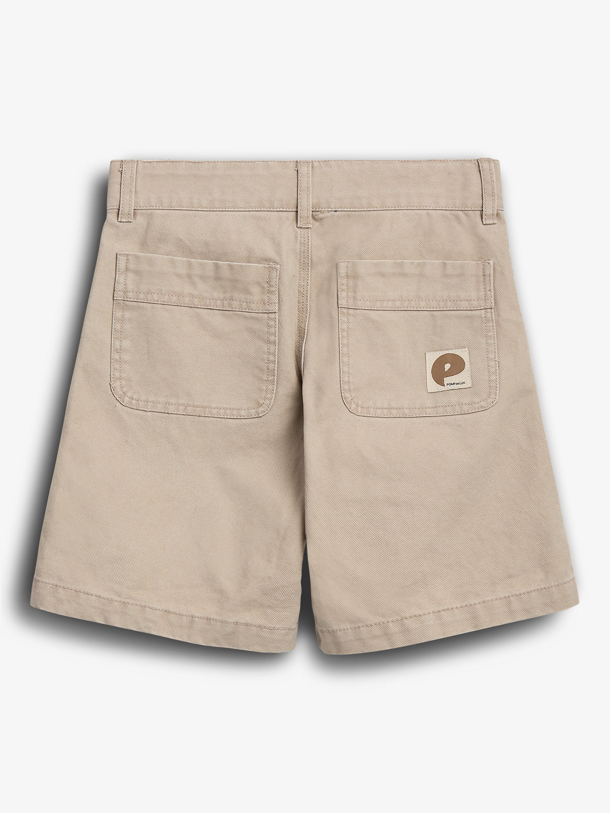 Beige shorts lie flat showing their back, featuring two pockets and a small logo with the letter "P" and "POP TRADING" on the right pocket, against a plain background.