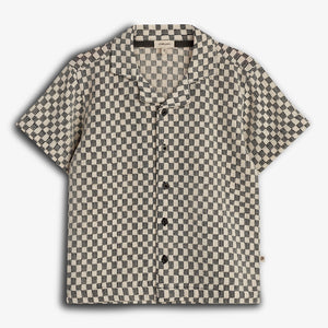 Short-sleeved, button-up shirt featuring a black and beige checkered pattern, displayed against a plain white background. The shirt has a pointed collar and the label "Pine & Lake."