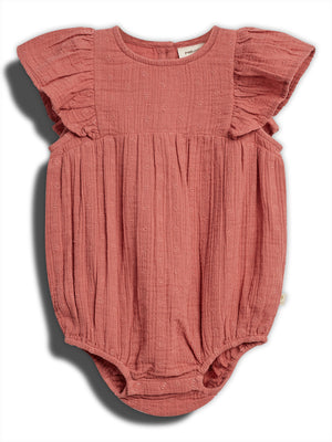 A pink baby romper with ruffled sleeves, featuring small embroidered patterns, lies flat against a white background. It has buttons at the bottom for fastening and a visible inner label.