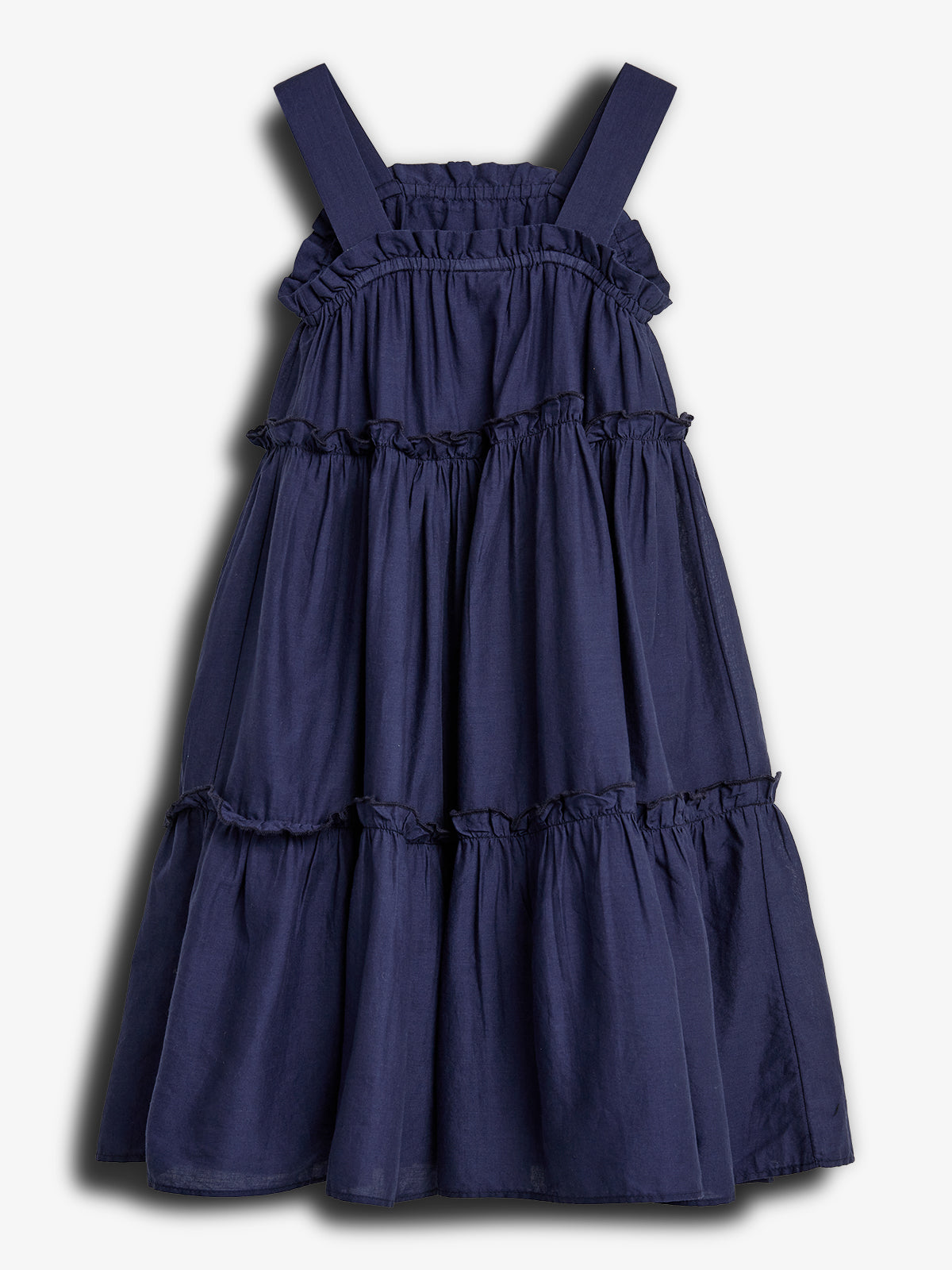 A navy blue sleeveless dress hangs flat, featuring tiered ruffles and wide shoulder straps. It rests against a plain, light background.