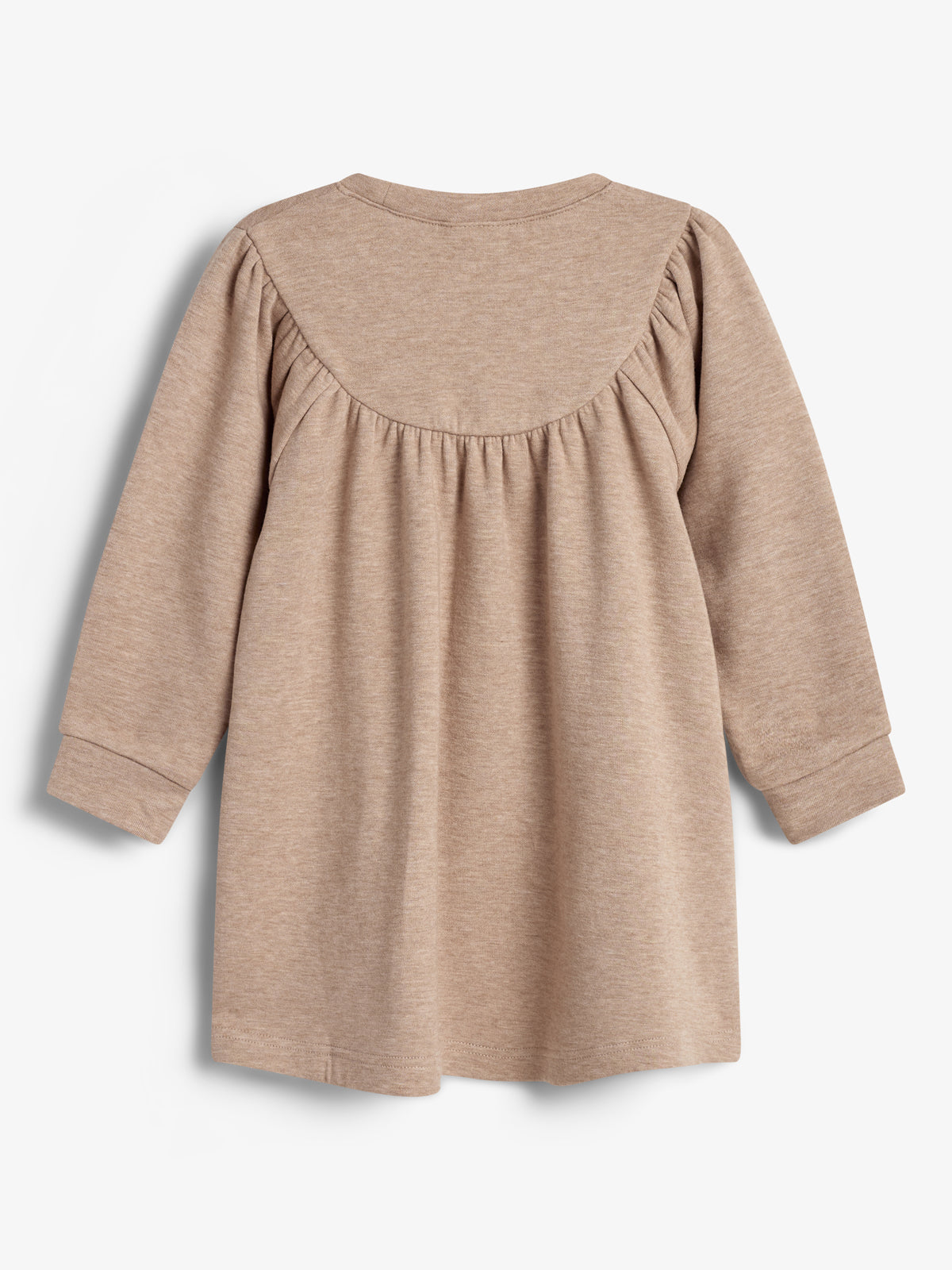 A long-sleeved beige dress hangs flat, showcasing its back design with gathered fabric along the yoke, creating pleats. The plain, neutral background emphasizes the garment's simple, elegant style.
