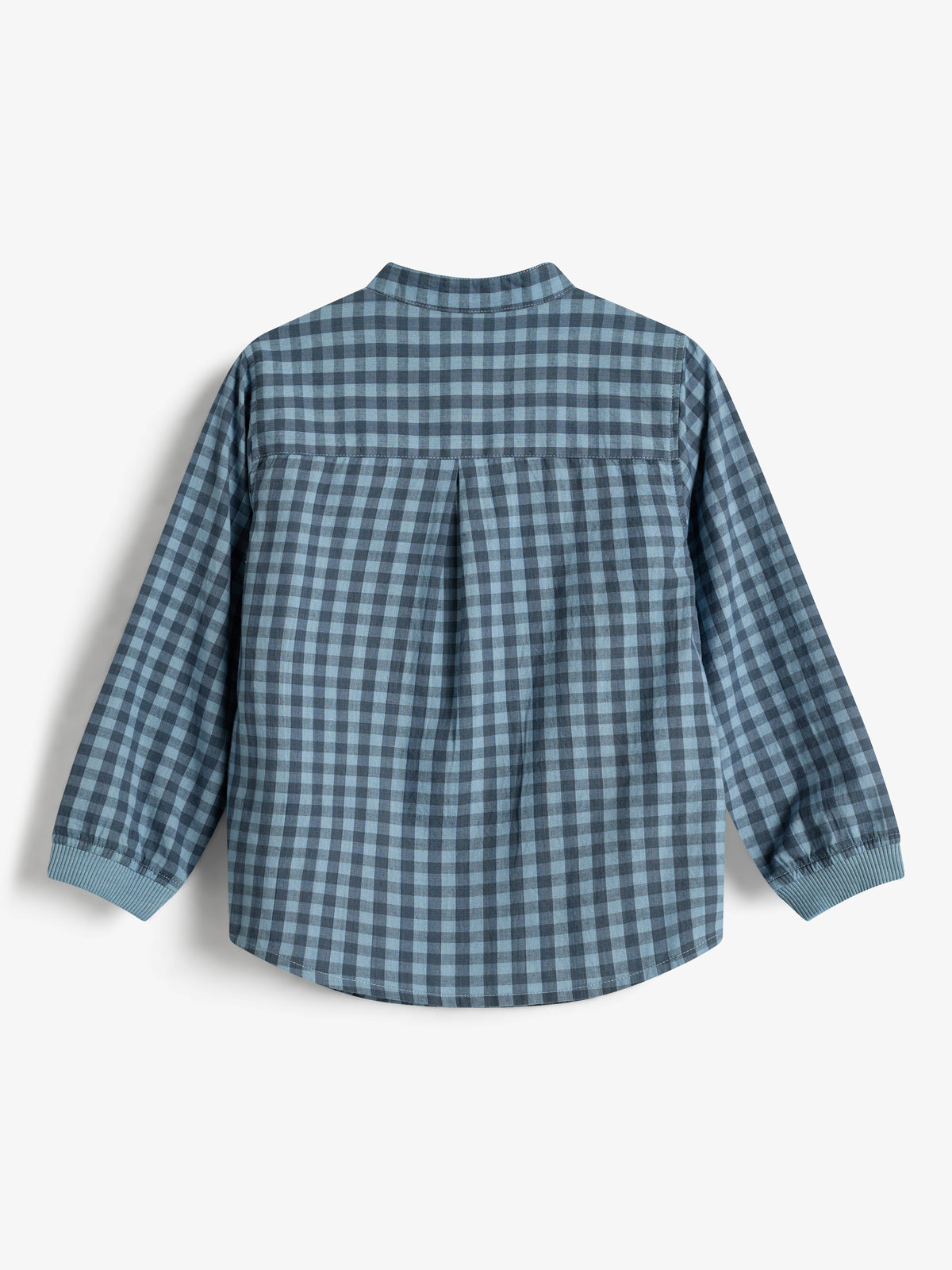 A long-sleeved, blue checkered shirt with a pleated back hangs against a plain white background. The shirt features ribbed cuffs and a simple collar design.