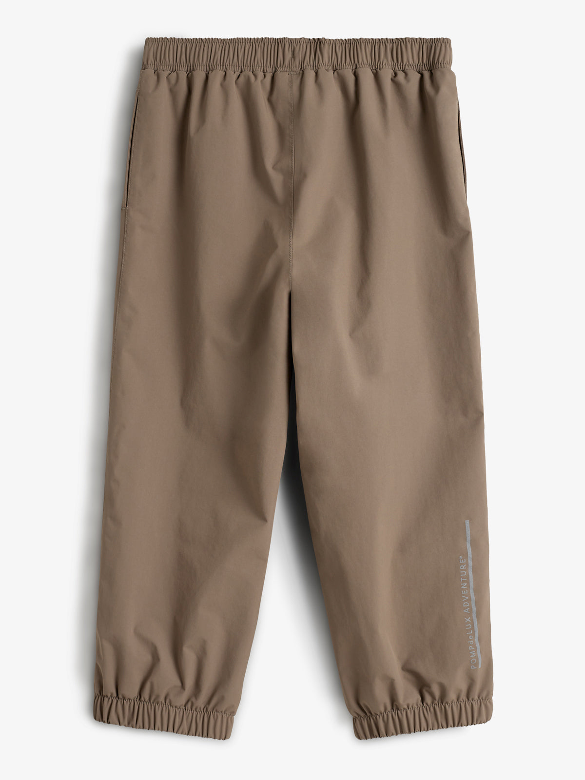 Brown children's pants, featuring elastic waist and cuffs, lie flat against a plain background. The right leg displays the text "POLAR ADVENTURE."