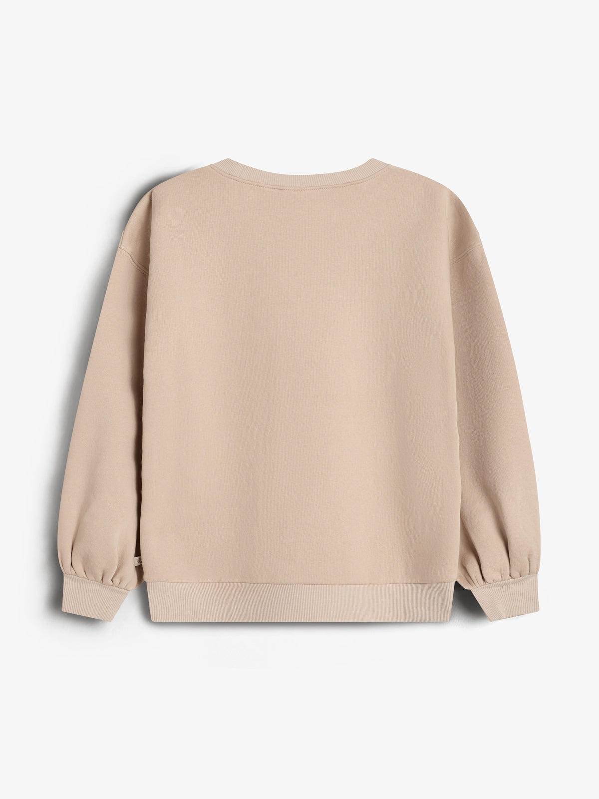 A beige sweatshirt hangs against a plain white background. It has long sleeves with ribbed cuffs and a ribbed hem.